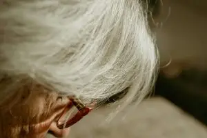 A focused close-up of a senior adult wearing glasses, highlighting wisdom and experience.